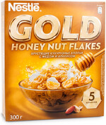 Хлопья Nestle Gold Flakes хрустящие кукурузные с медом и арахисом 300г